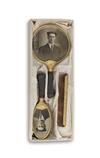 (POP PHOTOGRAPHICA) Pair of specialty accessories: a customized mens grooming set with a comb, brush and mirror, in the original box;